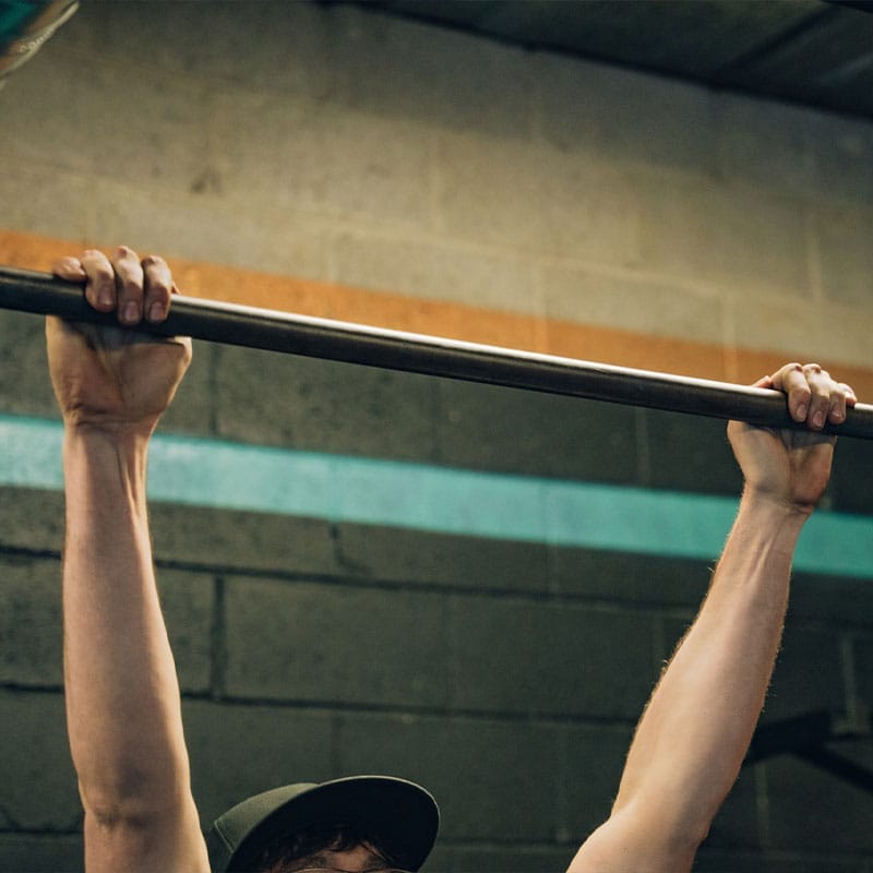 Teen working out on pull up bar