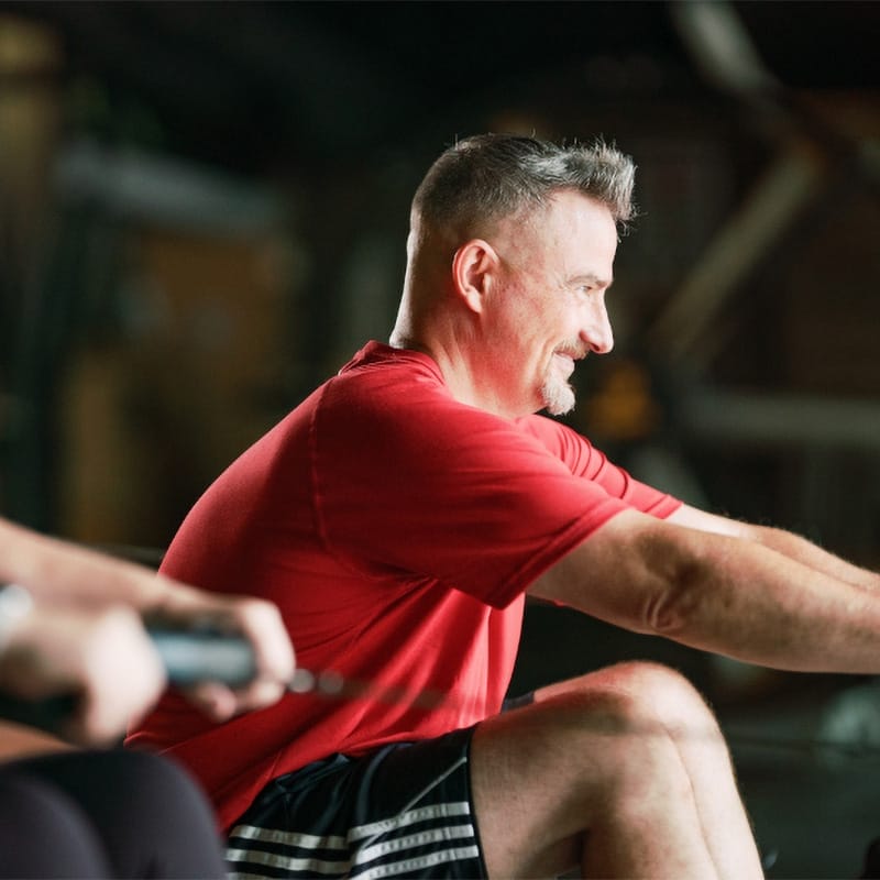 man working out on rower